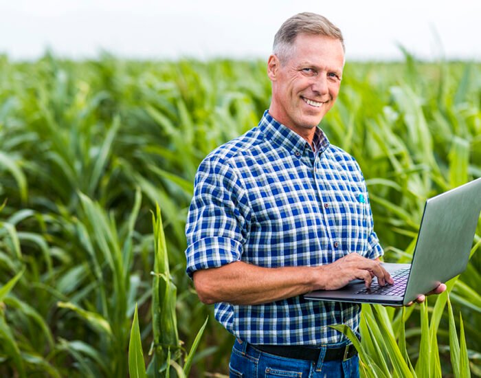 man-looking-camera-with-laptop